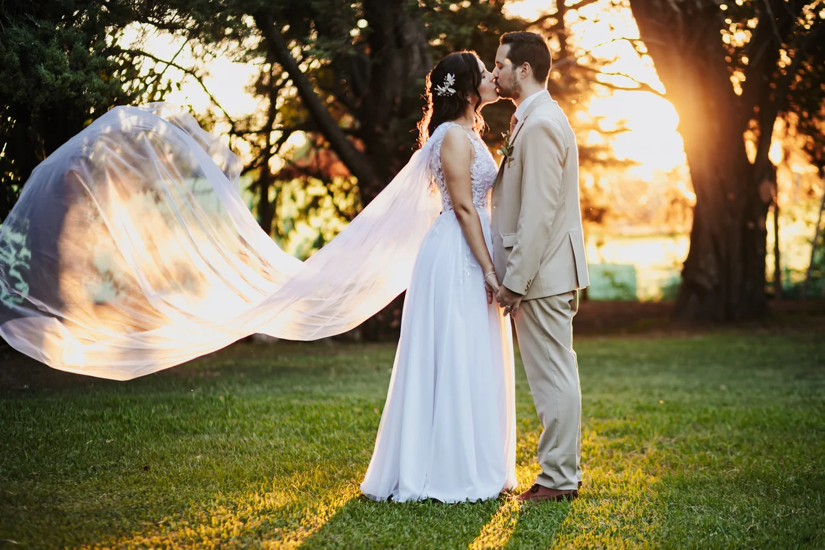 Los novios y el velo al atardecer · Kuma Studio